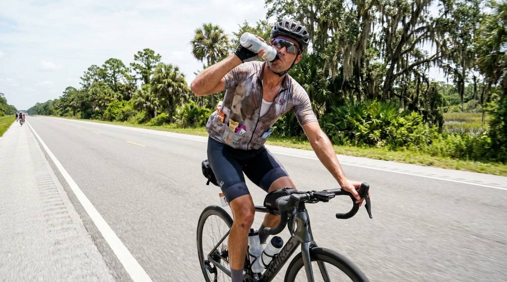 Cyclist drinking from a bottle during a long century ride in Florida