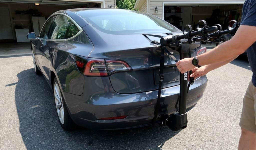 Thule trunk bike rack mounted securely on a car rear hatch